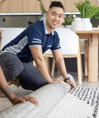 Restoration technician working at floor level